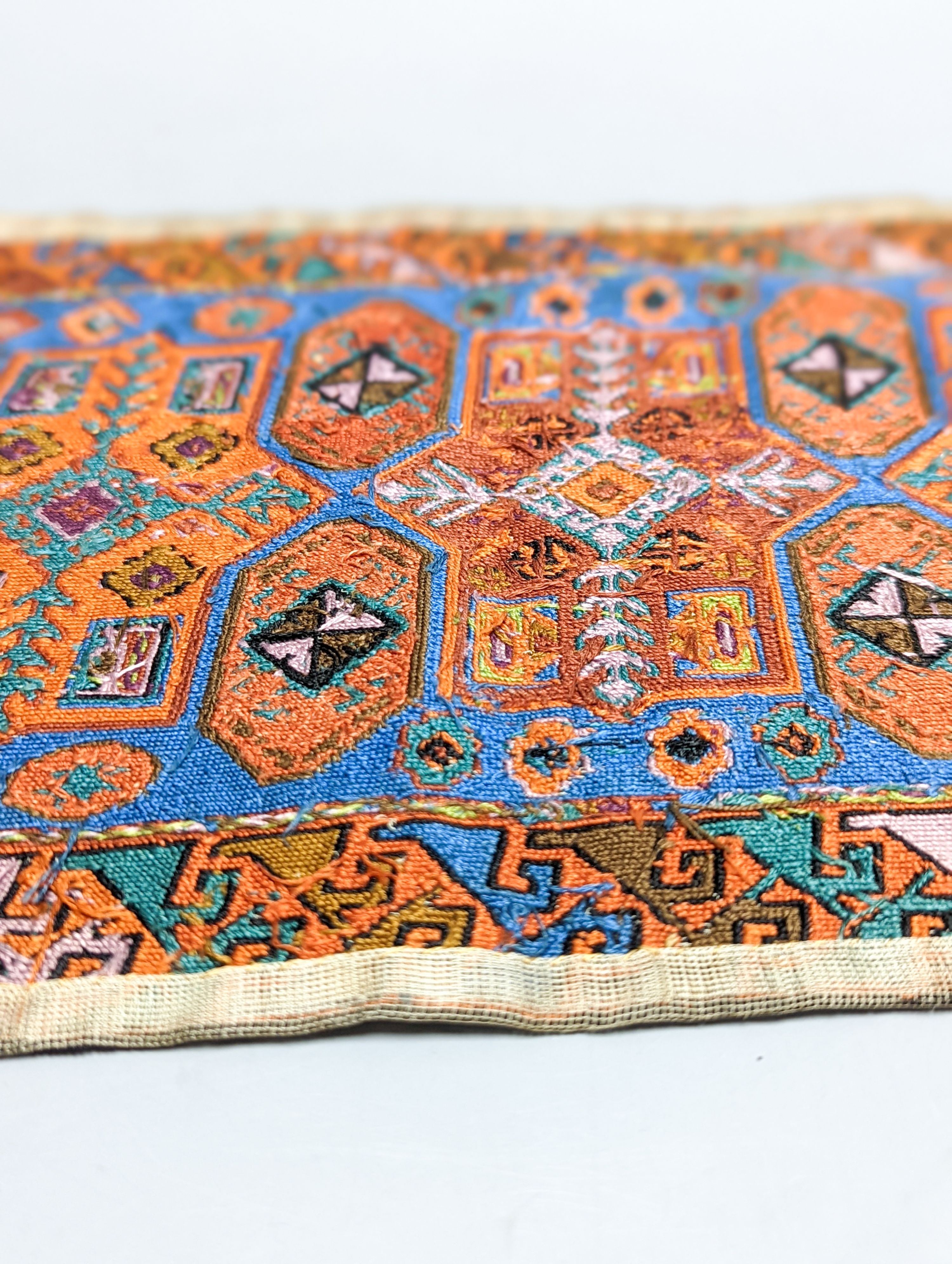 A Caucasian style petit point miniature rug 33x20cm